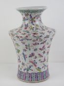 A Chinese vase having Guangxu style butterfly decoration in pinks and turquoise,