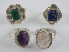Four hardstone rings each stamped 925, size T-V, including rose quartz and lapis lazuli.