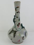 An Oriental grey crackle glazed bottle vase having applied lizard decoration upon and handpainted