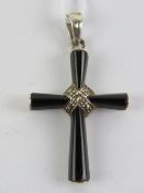 A silver and onyx crucifix having marcasites upon, stamped 925, 4.7cm in length inc bale.
