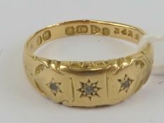 An 18ct gold Gypsy ring having three star set diamonds, hallmarked Chester, size N, 2.1g.
