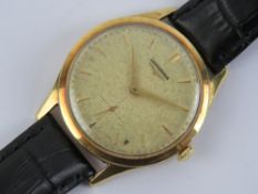 An 18ct gold Longines wristwatch having champagne dial with yellow metal hands, case hallmarked 750,