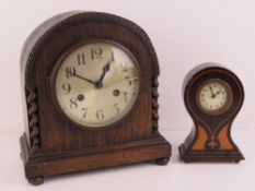 An Edwardian inlaid balloon clock having Arabic numerals before the clockwork movement, 17cm high.