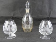 A large pair of etched glass brandy balloons, one having a fishing theme and one with hunting theme.