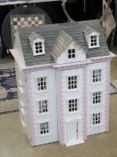 A large Victorian style dolls house having lighting, flooring, wallpaper, curtains etc. 67.5 x 49.