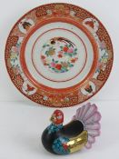An Oriental pottery figurine of a Turkey having gilt wings,