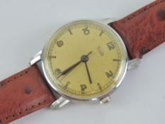 A c1950s Tudor wristwatch having champagne dial and leather strap.