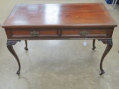 An Edwardian mahogany twin drawer freize table raised over shaped slender cabriole legs terminating