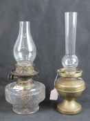 Two Victorian oil lamps; one glass and one brass.