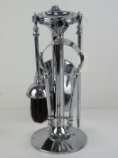 An Art Deco chrome companion fireside set comprising poker, tongs, shovel and brush,