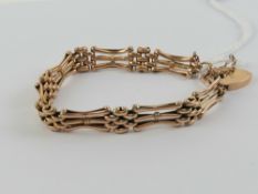 A 9ct gold three bar articulated bracelet with heart padlock clasp, stamped 9ct,