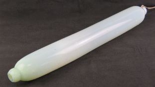 A 19th century milk glass oversized 'rolling pin', 75cm in length.