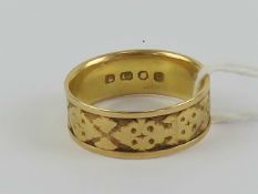 An 18ct gold wide band having Celtic style pattern upon, London hallmark, size Q, 5g.