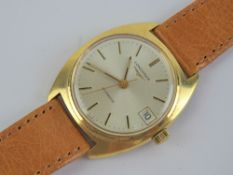A vintage Longines automatic wristwatch on leather strap, silvered dial with date aperture.