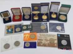 Four boxed mint collectors coins together with ten collectors coins in protective pod/packages.