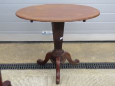 An oval side table raised over hexagonal tapering stem on three outswept legs, 83 x 57cm.