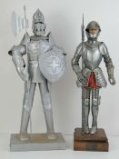 Two miniature models in suits of armour.