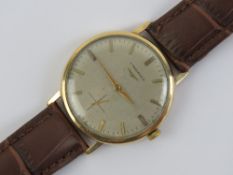 A 9ct gold Longines wristwatch having silvered dial with yellow metal hands, case hallmarked 375,