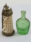 A carved bone scent bottle having geometric pattern with metal fittings, standing 7cm high.