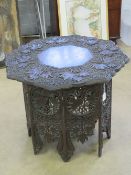 An Indo-Asian octagonal table, pierced and carved throughout, top approx 75cm dia.