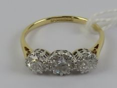 An 18ct gold three stone diamond ring, the central stone approx 0.