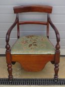 A late Victorian mahogany bar back commode chair with ceramic insert (freshly emptied).
