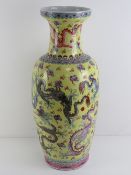 A 20th century Oriental export oversize shoulder vase in yellow ground decorated with mythical