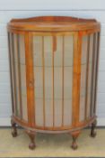 A glazed demi lune cabinet, 89cm wide, 33cm deep, 125cm high.