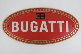 A fine and heavy 20th Century Bugatti-themed cast metal oval wall sign measuring 35 x 17.