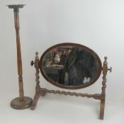 A c1930s stained oak smokers receptacle on stand, together with an oval toilet mirror on stand.