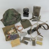 A quantity of assorted militaria; K98 cleaning kit, reproduction SS helmet cover, bayonet frog,