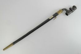 An 1853 pattern Martini Henry bayonet having inspection marks upon with leather and brass scabbard
