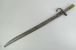 A Remington rolling block bayonet with brass grip, quillion, 57.5cm blade, with scabbard.