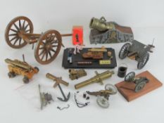A quantity of assorted decorative cannons and accessories.