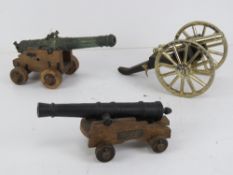Three decorative cannons each approx 21cm in length.