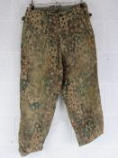 A pair of reproduction WWII German SS dot camouflage trousers.