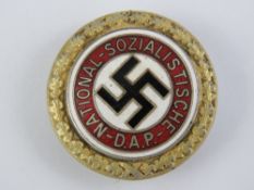 A reproduction WWII German gold party badge.