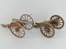 Two decorative steel and wood cannons, each approx. 43 cm long x 17cm high.