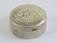 A 925 silver pill pot, hinged lid having floral engraving upon. 3cm diameter.
