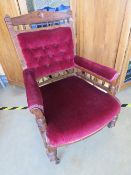 An Edwardian part button back elbow chair having turned baluster decoration throughout and raised