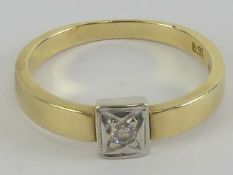 A 14ct gold ring having illusion set white stone in white metal square head,
