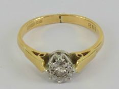 An 18ct gold ring having illusion set diamond in white metal star shaped setting, hallmarked 750,