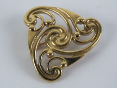 A 9ct gold art nouveau style triangular brooch, hallmarked 375 and measuring 2.8cm wide, 6.3g.