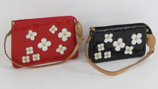 Two handbags having daisies upon. Red bag 24cm wide, black bag 21cm wide.
