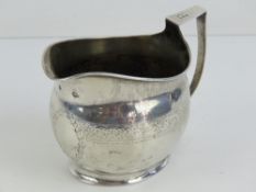 A Georgian silver jug having partial hallmark upon including kings head and lion rampant,