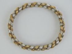 A 9ct white and yellow gold hinged bangle in rope twist pattern hallmarked 375, internal dia 5.