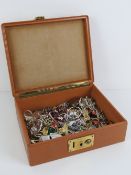 A vintage pigskin leather travelling jewellery case having London made brass lock and containing a