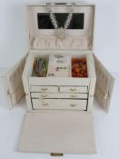A white leather jewellery box containing a quantity of assorted costume jewellery including glass