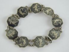A niello sterling silver articulated bracelet having nine octagonal panels each featuring