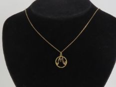 A 9ct gold 'M' pendant,